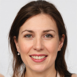 Joyful white adult female with medium  brown hair and grey eyes