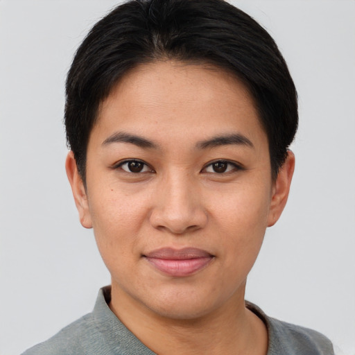 Joyful asian young-adult female with short  black hair and brown eyes