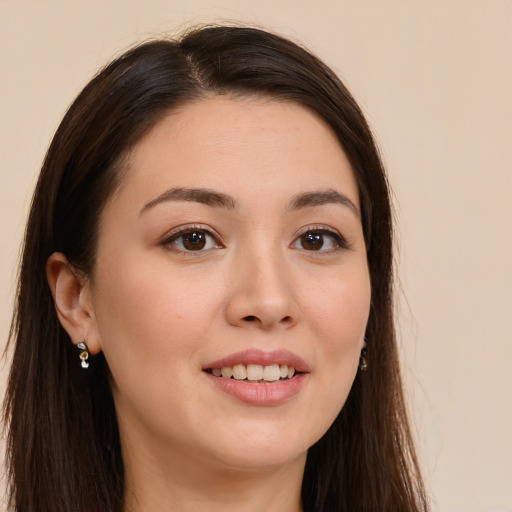 Joyful white young-adult female with long  brown hair and brown eyes