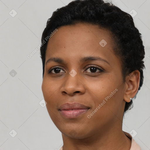 Joyful black young-adult female with short  black hair and brown eyes