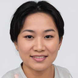 Joyful asian young-adult female with short  brown hair and brown eyes