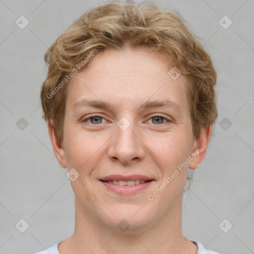 Joyful white young-adult female with short  brown hair and grey eyes