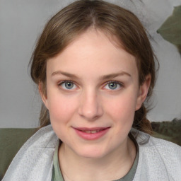 Joyful white young-adult female with medium  brown hair and blue eyes