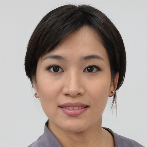 Joyful asian young-adult female with medium  black hair and brown eyes