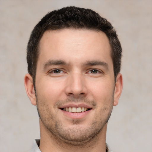 Joyful white young-adult male with short  brown hair and brown eyes