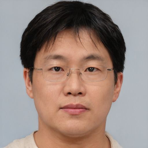 Neutral asian adult male with short  brown hair and brown eyes