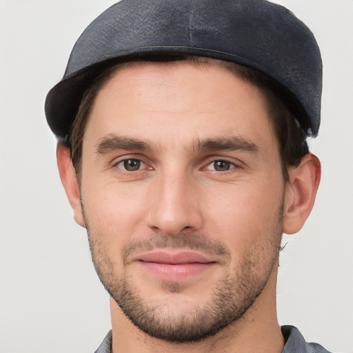 Joyful white young-adult male with short  black hair and brown eyes