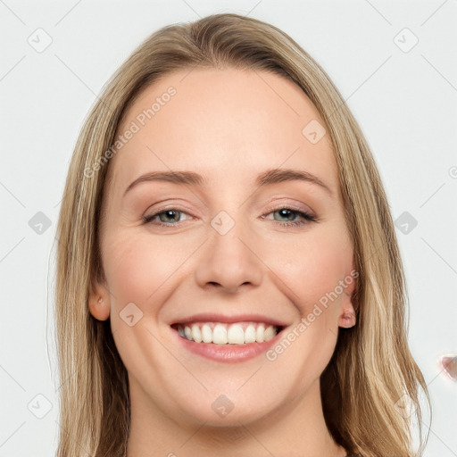 Joyful white young-adult female with long  brown hair and green eyes