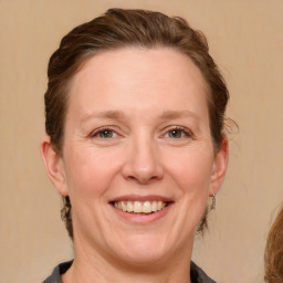 Joyful white adult female with medium  brown hair and grey eyes