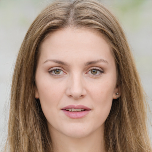 Joyful white young-adult female with long  brown hair and green eyes