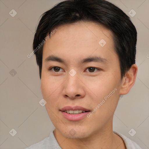 Joyful asian young-adult male with short  brown hair and brown eyes