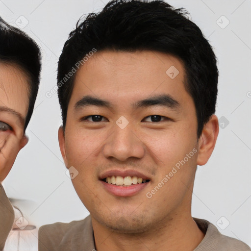 Joyful asian young-adult male with short  black hair and brown eyes