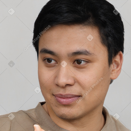 Joyful asian young-adult male with short  black hair and brown eyes