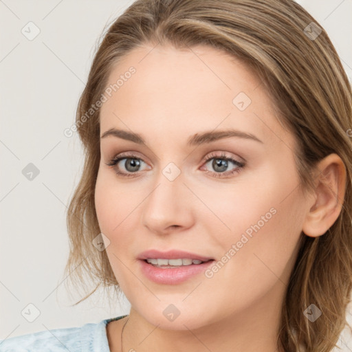 Joyful white young-adult female with medium  brown hair and blue eyes