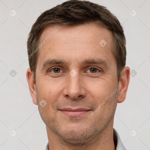 Joyful white adult male with short  brown hair and brown eyes