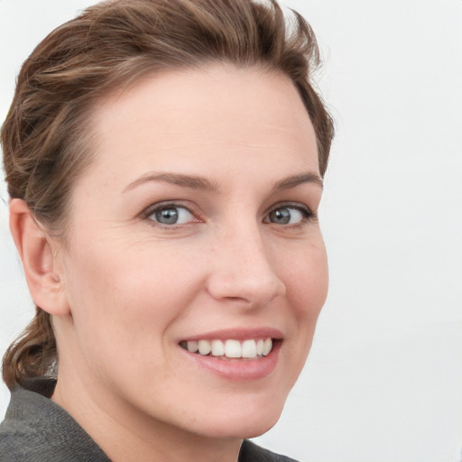 Joyful white young-adult female with medium  brown hair and blue eyes