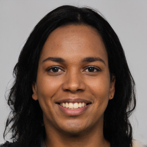 Joyful latino young-adult female with long  black hair and brown eyes