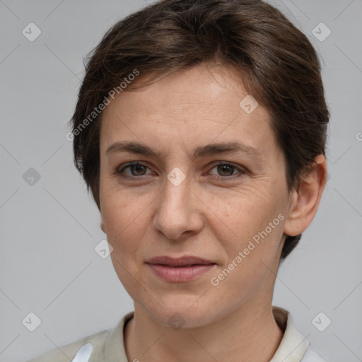 Joyful white adult female with short  brown hair and grey eyes