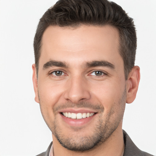 Joyful white young-adult male with short  brown hair and brown eyes