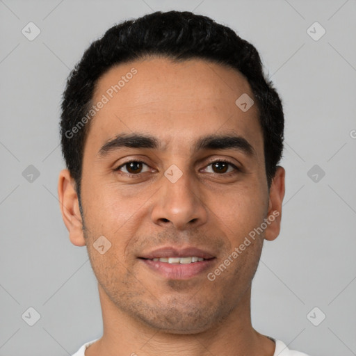 Joyful latino young-adult male with short  black hair and brown eyes