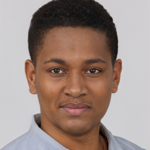 Joyful black young-adult male with short  brown hair and brown eyes