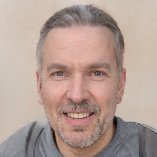 Joyful white middle-aged male with short  gray hair and brown eyes