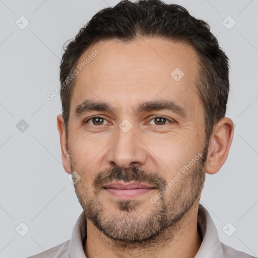 Joyful white adult male with short  brown hair and brown eyes