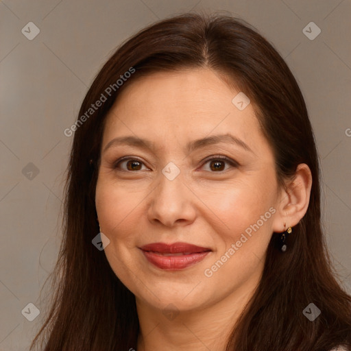 Joyful white adult female with long  brown hair and brown eyes