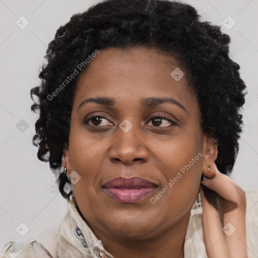 Joyful black adult female with short  brown hair and brown eyes