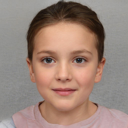 Joyful white child female with short  brown hair and brown eyes