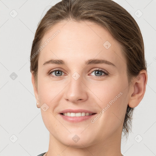 Joyful white young-adult female with medium  brown hair and grey eyes