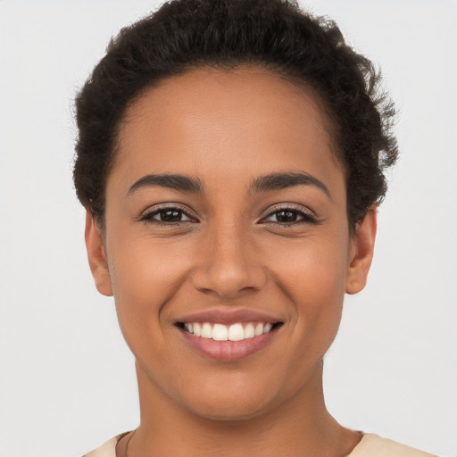 Joyful latino young-adult female with short  brown hair and brown eyes