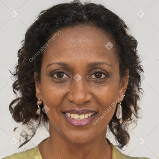 Joyful black adult female with medium  brown hair and brown eyes