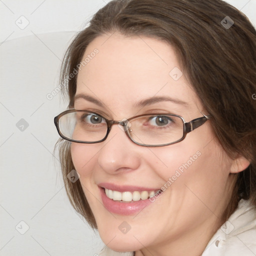 Joyful white young-adult female with medium  brown hair and grey eyes