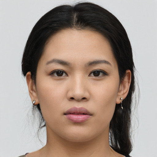 Joyful asian young-adult female with long  black hair and brown eyes