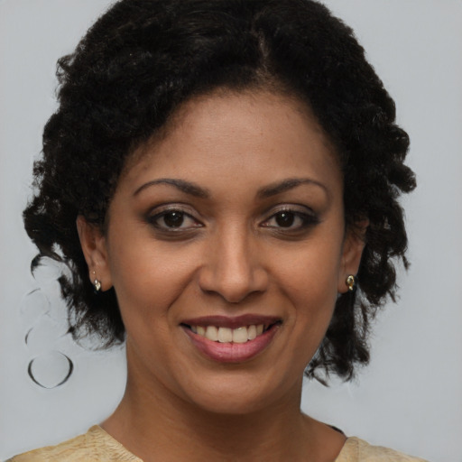 Joyful black young-adult female with medium  brown hair and brown eyes