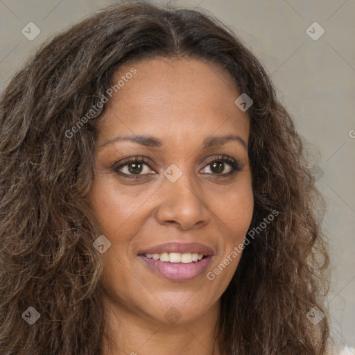 Joyful black young-adult female with long  brown hair and brown eyes