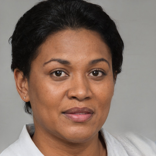Joyful latino adult female with short  brown hair and brown eyes