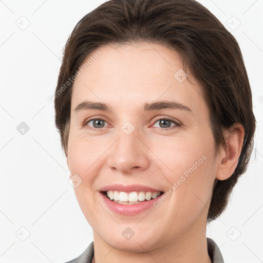 Joyful white young-adult female with short  brown hair and brown eyes