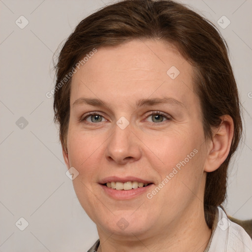 Joyful white adult female with medium  brown hair and grey eyes