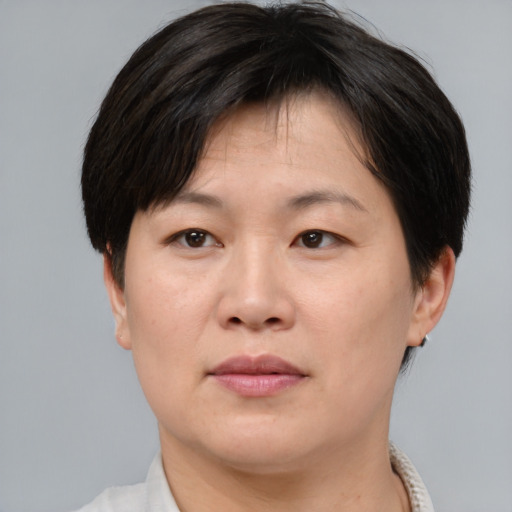 Neutral asian adult female with short  brown hair and brown eyes