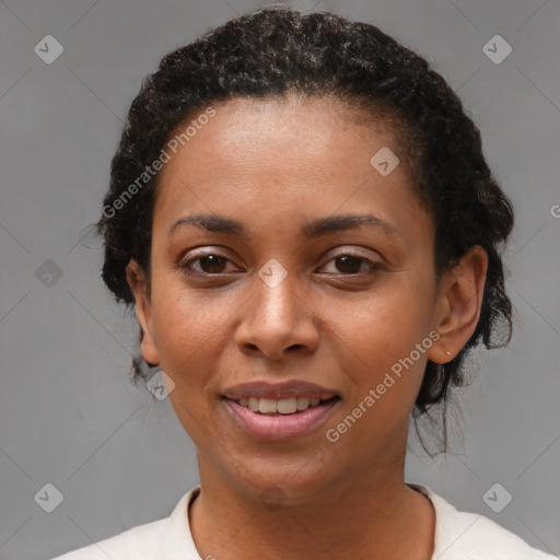 Joyful black young-adult female with short  brown hair and brown eyes