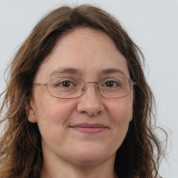 Joyful white adult female with long  brown hair and brown eyes