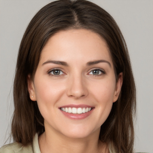 Joyful white young-adult female with long  brown hair and grey eyes