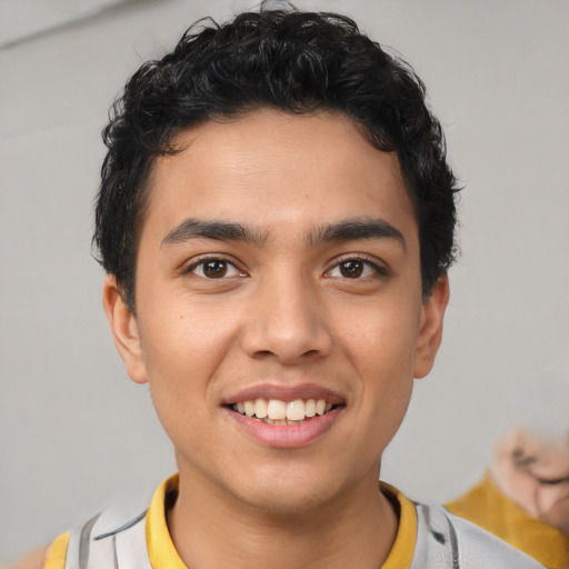 Joyful latino young-adult male with short  brown hair and brown eyes