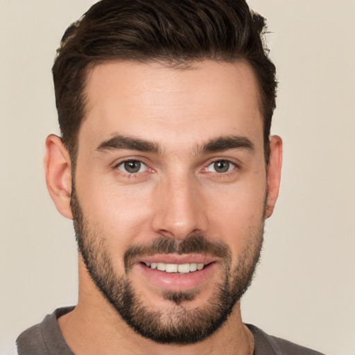 Joyful white young-adult male with short  brown hair and brown eyes