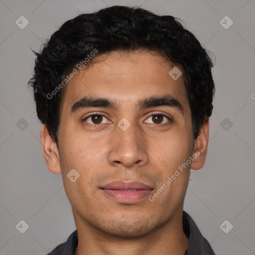 Joyful latino young-adult male with short  brown hair and brown eyes