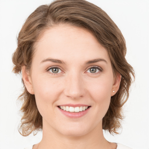 Joyful white young-adult female with medium  brown hair and green eyes