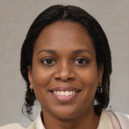 Joyful black young-adult female with medium  brown hair and brown eyes