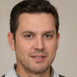 Joyful white adult male with short  brown hair and brown eyes